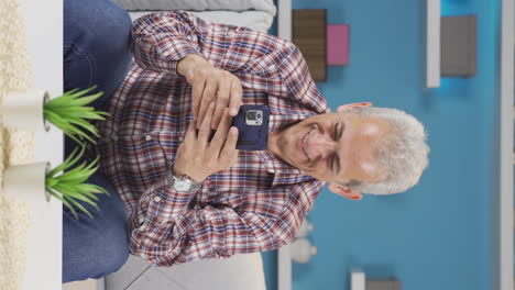 Vertical-video-of-Happy-and-happy-texting-man.